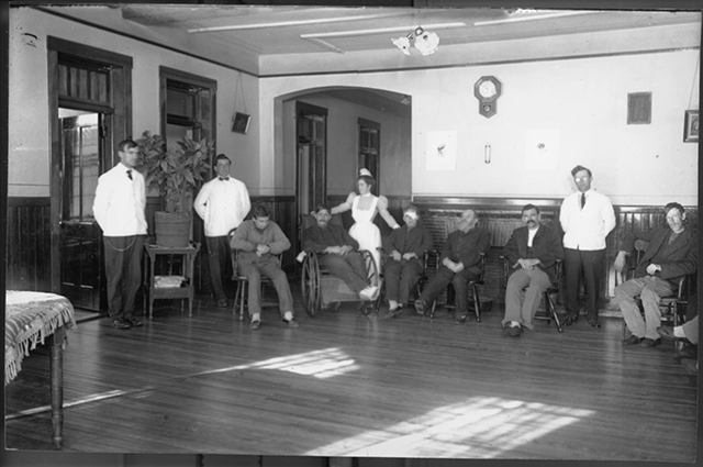 Black and white photograph of 4 staff members and 6 patients at the state hospital from about 1900.